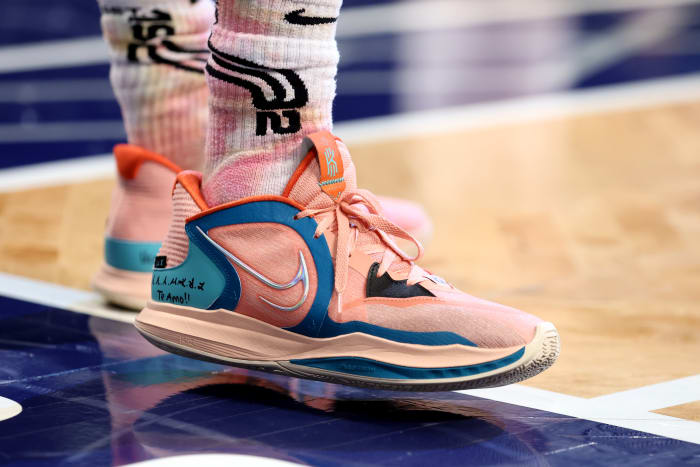 View of pink Kyrie basketball shoes.